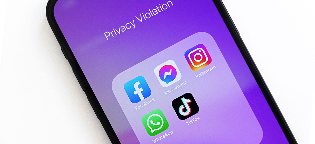 Angled cropped close-up of a purple mobile screen witht he words privacy violation and the Facebook, Messenger, Instagram, WhatsApp and TickTok apps being displayed.